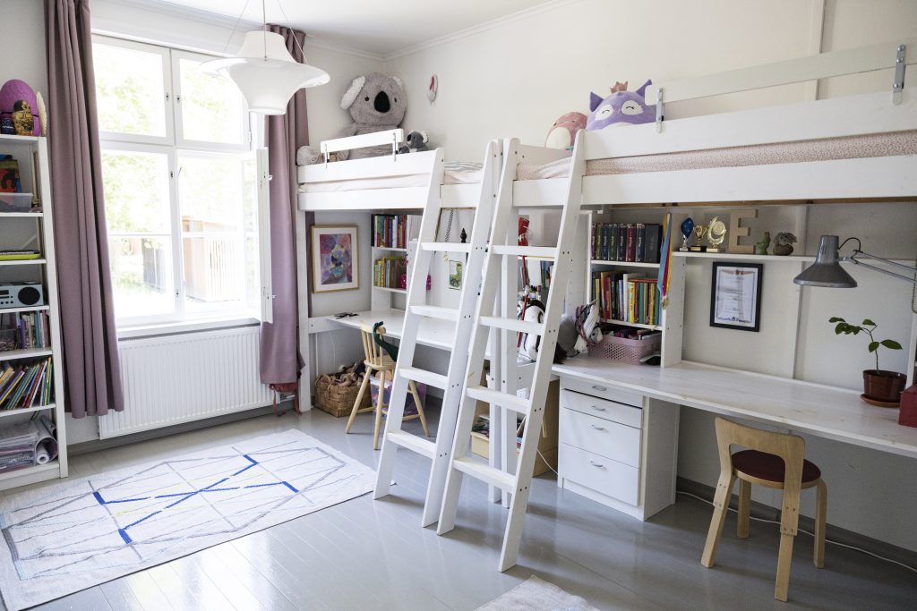 A children´s room with two loft beds next to each other.