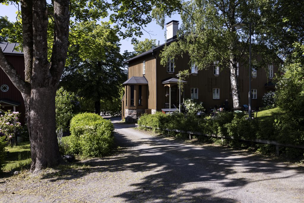 A brown house in a garden.